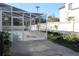 Backyard view of an enclosed pool with lush landscaping, offering a private outdoor retreat at 6225 Imperial Ky, Tampa, FL 33615