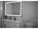 Bathroom featuring a vanity with quartz countertop, modern faucet, and an illuminated LED mirror at 6225 Imperial Ky, Tampa, FL 33615