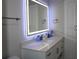 Modern bathroom featuring sleek vanity with lighted mirror, offering a spa-like experience at 6225 Imperial Ky, Tampa, FL 33615