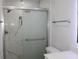 Elegant bathroom featuring a glass shower door, marble tile, and sleek chrome fixtures at 6225 Imperial Ky, Tampa, FL 33615
