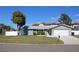 Charming single-story home featuring a well-manicured lawn, driveway, garage, and beautifully painted exterior at 6225 Imperial Ky, Tampa, FL 33615