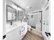 Bathroom with double sinks, granite countertops, and a modern glass shower at 6511 Senegal Palm Way, Apollo Beach, FL 33572
