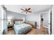 Comfortable bedroom features a decorative ceiling fan, wood flooring, and a calming color scheme at 6511 Senegal Palm Way, Apollo Beach, FL 33572