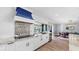 Bright kitchen with white cabinets, marble countertops, and a unique backsplash design, complemented by modern appliances at 6511 Senegal Palm Way, Apollo Beach, FL 33572