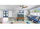 Bright living room with turquoise accents, plantation shutters, and modern furnishings creating a welcoming ambiance at 6511 Senegal Palm Way, Apollo Beach, FL 33572