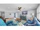 Light-filled living room featuring light blue walls, modern furnishings, and stylish decor at 6511 Senegal Palm Way, Apollo Beach, FL 33572