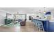 Open concept living area with kitchen, kitchen island with seating, living room and hardwood flooring at 6511 Senegal Palm Way, Apollo Beach, FL 33572