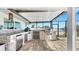 Outdoor kitchen with stainless steel appliances and stone countertops perfect for entertaining at 6511 Senegal Palm Way, Apollo Beach, FL 33572