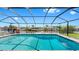 A screened-in pool with brick trim and unobstructed views of the canal, perfect for relaxation and entertainment at 6511 Senegal Palm Way, Apollo Beach, FL 33572