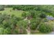 Expansive aerial view of a charming home nestled within lush green trees at 7249 Berry Rd, Zephyrhills, FL 33540