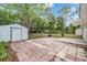 Expansive backyard features a patio with brick pavers and a convenient storage shed at 7249 Berry Rd, Zephyrhills, FL 33540