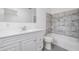 Updated bathroom featuring white vanity, brushed nickel faucet, and tiled shower/tub combo at 7249 Berry Rd, Zephyrhills, FL 33540