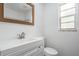 Bathroom features include a vanity and a mirror. Natural light is provided by a window at 7249 Berry Rd, Zephyrhills, FL 33540