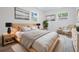 Calming bedroom with two windows, wood-look floors, neutral decor, and modern lamps at 7249 Berry Rd, Zephyrhills, FL 33540