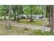 Charming home exterior with well-maintained yard and a long, winding driveway at 7249 Berry Rd, Zephyrhills, FL 33540