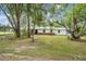 Charming exterior view of the home with a walkway leading to the front door at 7249 Berry Rd, Zephyrhills, FL 33540