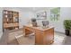 Bright home office featuring large desk, bookcase, rug, and large picture window at 7249 Berry Rd, Zephyrhills, FL 33540