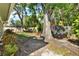 Beautiful backyard with mature trees, verdant landscaping, and privacy fence at 7591 Harbor View Way, Seminole, FL 33776