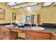Bright bathroom features a double vanity, a large mirror, and a skylight at 7591 Harbor View Way, Seminole, FL 33776