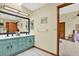 Bathroom featuring dual sinks, skylight and tile floors, and view to bedroom at 7591 Harbor View Way, Seminole, FL 33776