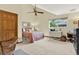 Bedroom with a full-sized bed, wooden desk and chair, large window, and ceiling fan at 7591 Harbor View Way, Seminole, FL 33776