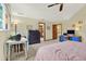Bedroom with full bed, desk, bureau, and view to the stairs and bathroom at 7591 Harbor View Way, Seminole, FL 33776