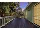 Green wooden deck with natural tree views and exterior home siding at 7591 Harbor View Way, Seminole, FL 33776