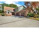 Charming two-story home with a brick exterior and three-car garage at 7591 Harbor View Way, Seminole, FL 33776