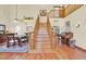 Grand foyer showcases a beautiful staircase, hardwood floors, and views of the dining room and living spaces at 7591 Harbor View Way, Seminole, FL 33776