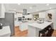 Bright, open kitchen featuring white cabinets, modern appliances, and a large island with seating at 7591 Harbor View Way, Seminole, FL 33776