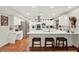 Bright kitchen featuring white cabinets, quartz countertops, stainless steel appliances, and a large island at 7591 Harbor View Way, Seminole, FL 33776