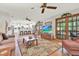 Open living area with hardwood floors, ceiling fans, and access to an outdoor area at 7591 Harbor View Way, Seminole, FL 33776