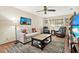 Cozy living room features a comfortable couch, plush seating, a coffee table, and natural light at 7591 Harbor View Way, Seminole, FL 33776