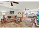 Spacious living room open to the kitchen featuring hardwood floors and comfortable seating at 7591 Harbor View Way, Seminole, FL 33776