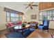 Cozy living room with hardwood floors, large windows, comfortable seating, and natural light at 7591 Harbor View Way, Seminole, FL 33776