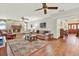 Inviting living room with a brick fireplace, hardwood floors, and comfortable seating at 7591 Harbor View Way, Seminole, FL 33776
