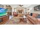 Cozy living room featuring a brick fireplace, comfortable seating, and natural light at 7591 Harbor View Way, Seminole, FL 33776