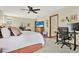 Bedroom featuring king bed, ceiling fan, television, and work from home desk at 7591 Harbor View Way, Seminole, FL 33776