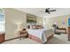 Spacious bedroom with king bed, ceiling fan, large windows, and a treadmill at 7591 Harbor View Way, Seminole, FL 33776