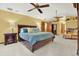 Spacious main bedroom features a ceiling fan, ensuite, and closet at 7591 Harbor View Way, Seminole, FL 33776