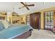Bright main bedroom with a ceiling fan and exterior view at 7591 Harbor View Way, Seminole, FL 33776