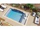 Top-down view of a custom pool with a waterfall feature and stylish outdoor seating areas at 7591 Harbor View Way, Seminole, FL 33776