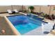 Backyard pool with lounge chairs, waterfall feature, and lush tropical landscaping for a relaxing outdoor experience at 7591 Harbor View Way, Seminole, FL 33776