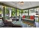 Relaxing covered porch seating area with plush cushions and serene garden views at 7591 Harbor View Way, Seminole, FL 33776