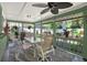 This covered porch offers an inviting outdoor dining space with garden views at 7591 Harbor View Way, Seminole, FL 33776