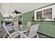 The covered porch offers an inviting space to enjoy outdoor dining and garden views at 7591 Harbor View Way, Seminole, FL 33776