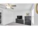 Bedroom with ceiling fan, large window, and modern dark wood dresser, creating a cozy atmosphere at 8299 Crescent Oaks Dr, New Port Richey, FL 34655