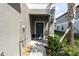 Inviting front door with gray stucco facade and stone landscaping detail and a pleasant, covered entryway at 8299 Crescent Oaks Dr, New Port Richey, FL 34655