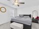 Cozy bedroom with ceiling fan, large window, and neutral decor, creating a peaceful retreat at 8299 Crescent Oaks Dr, New Port Richey, FL 34655