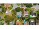 An aerial view displays a property's layout, highlighting its backyard pool and mature landscaping enclosed within property lines at 838 Park Ct, Palm Harbor, FL 34683